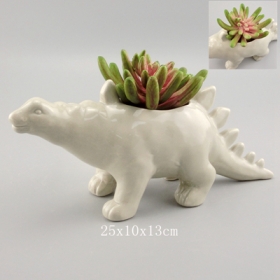 Plantador de dinossauro stegosaurus de cerâmica cinzenta com plantas